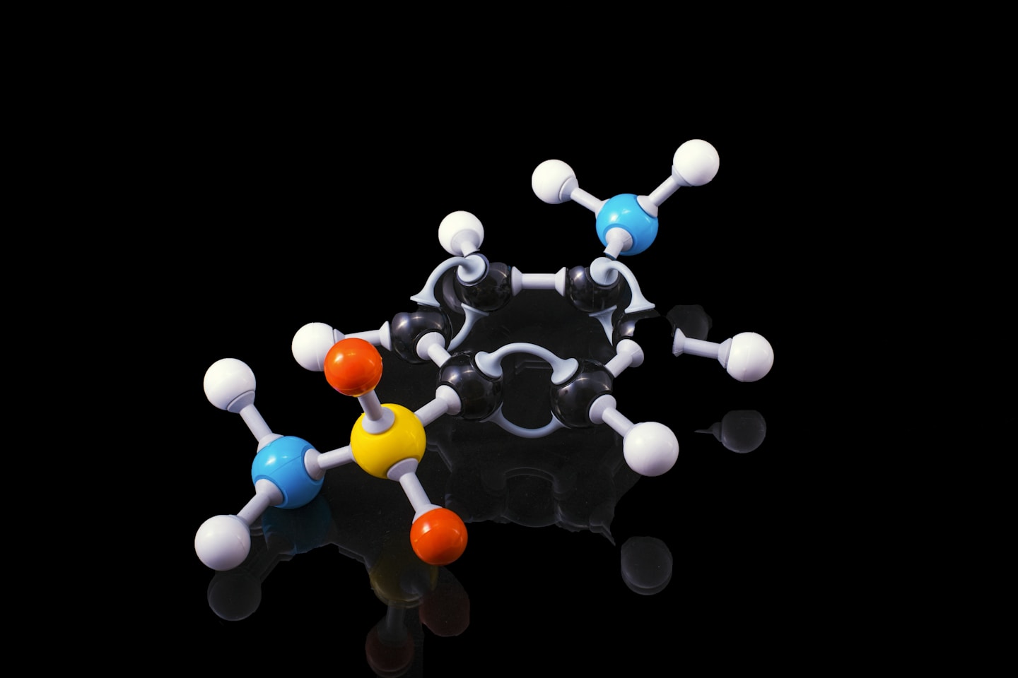 A molecule model with reflection on a dark surrounding. Sulfanilamide if someone is really interested !!
Sulfanilamide was a medicine used to treat streptococcal infections. One  version of the drug, in liquid form, was introduced in the market after  having being tested only for flavor, appearance and fragrance but not for toxicity. It caused the deaths of more than 100 people back in 1937. As we are all awaiting the cure for COVID19 let his be a reminder of what untested, unsafe and "rushed to market" drugs can do to people.