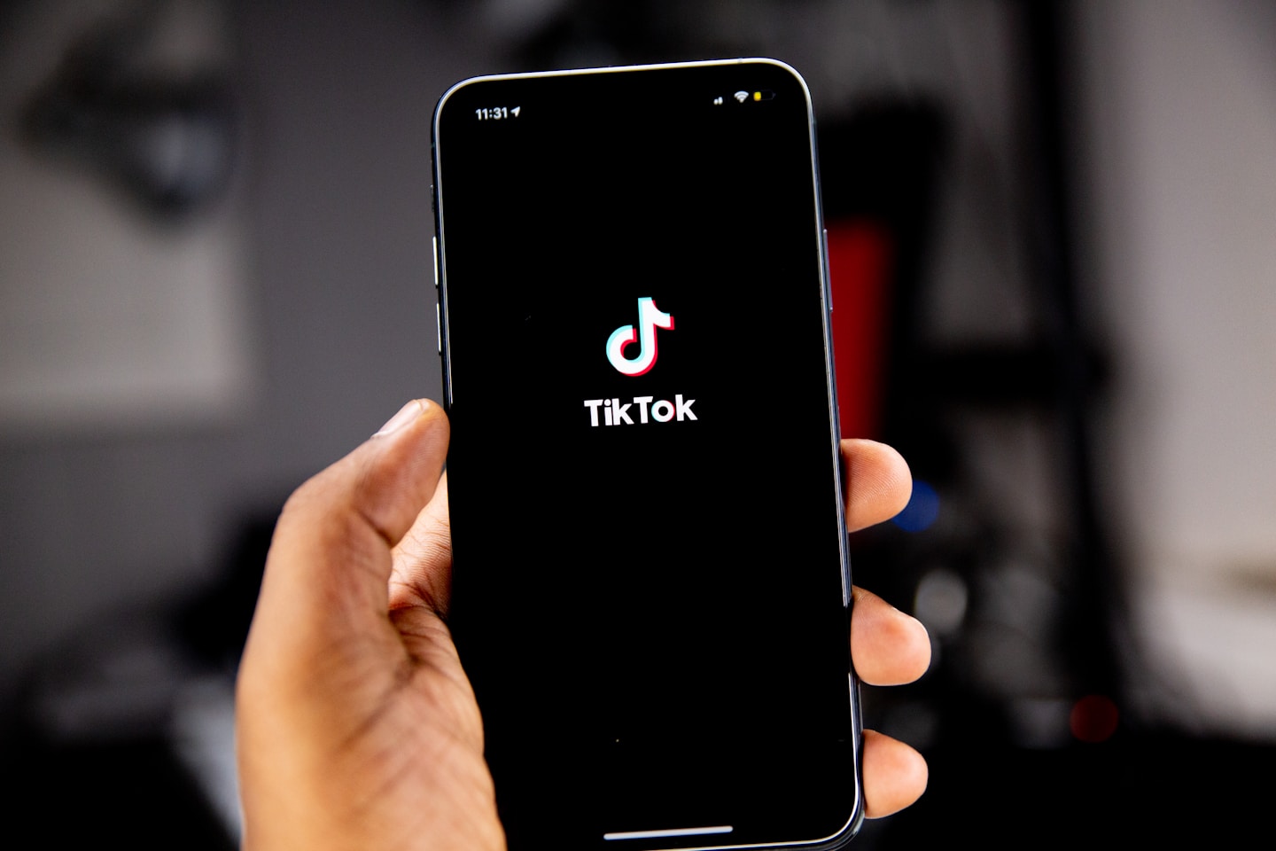 Person holding an iPhone running TikTok